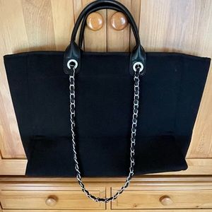 Black canvas tote with chain handles